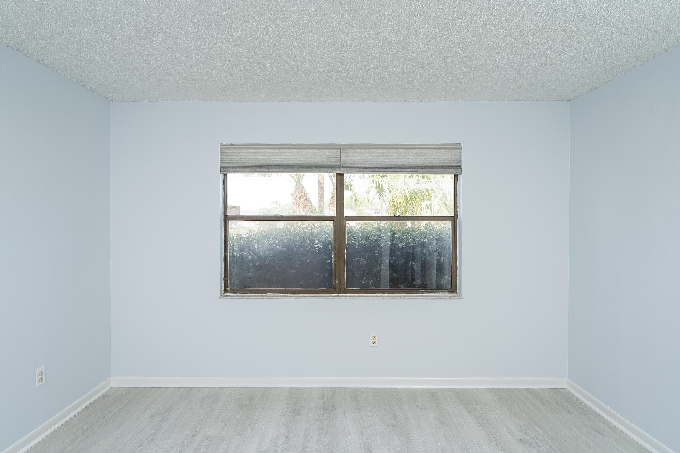 700 West Pope Road, Unit H57 St. Augustine, FL 32080 - Photo 23 of 52 Unfurnished room featuring light wood-style flooring and a textured ceiling