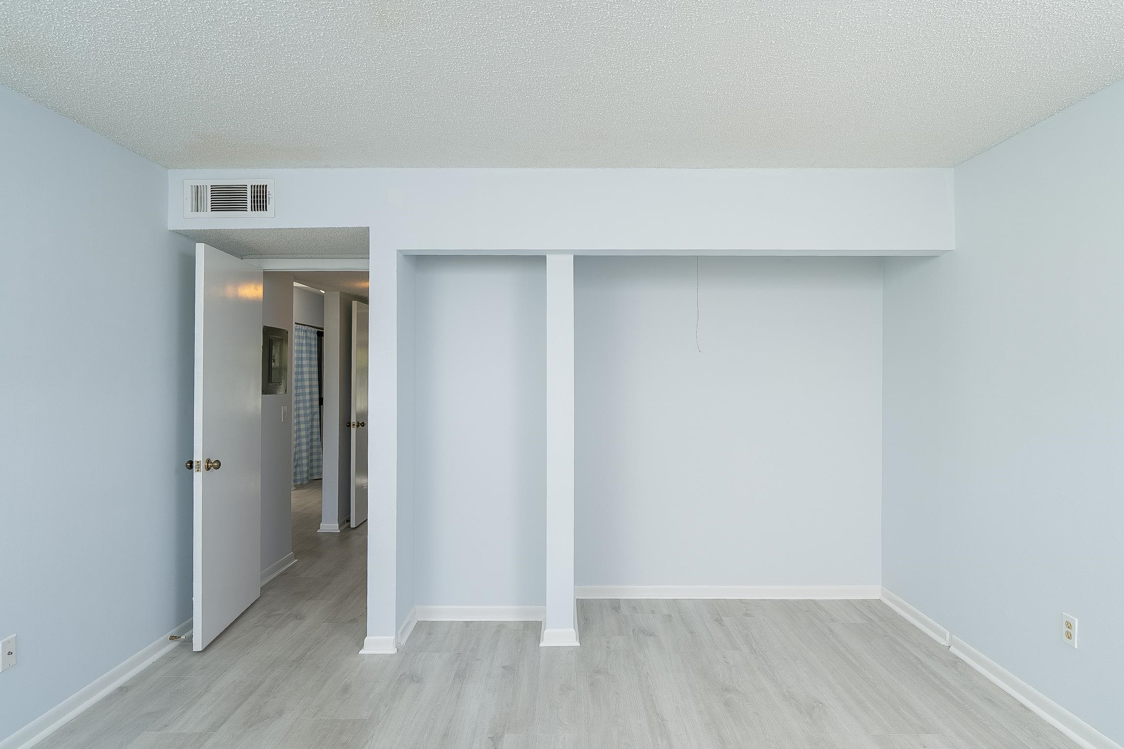 700 West Pope Road, Unit H57 St. Augustine, FL 32080 - Photo 24 of 52 Unfurnished bedroom with a textured ceiling, light wood-style flooring, and a closet