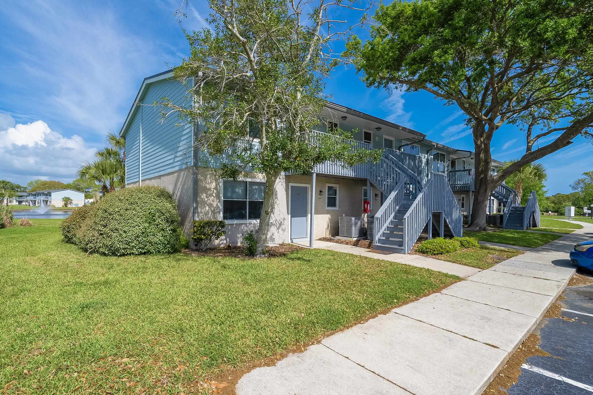 700 West Pope Road, Unit H57 St. Augustine, FL 32080 - Photo 3 of 52 View of front of home featuring a front lawn and stucco siding