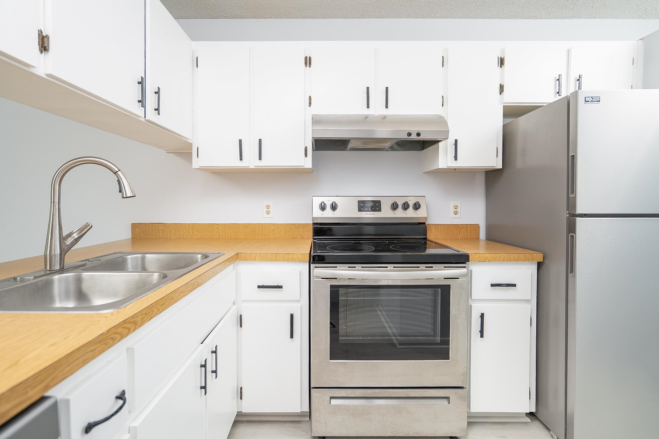 700 West Pope Road, Unit H57 St. Augustine, FL 32080 - Photo 8 of 52 Kitchen featuring stainless steel appliances, white cabinets, and light countertops