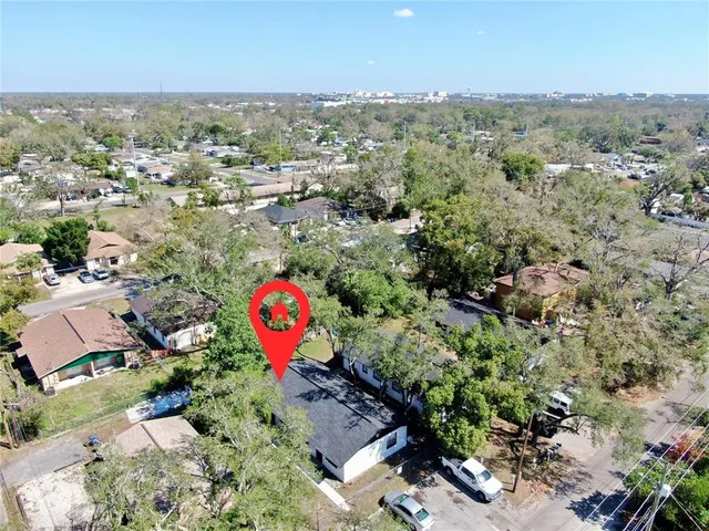 an aerial view of a houses with a swimming pool