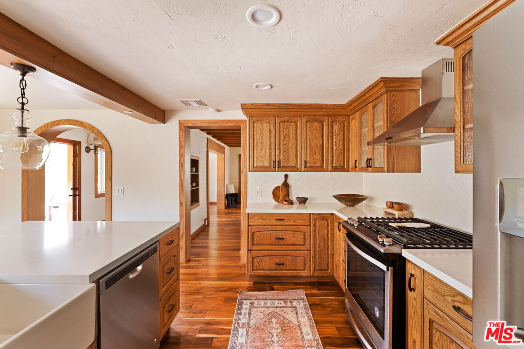 7900 Rim Canyon Road Sunland, CA 91040 - Photo 17 of 46 a kitchen with stainless steel appliances granite countertop a stove and a sink