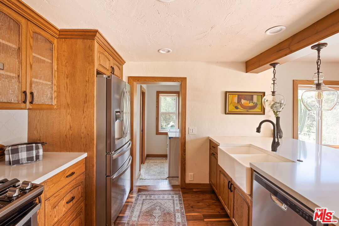 7900 Rim Canyon Road Sunland, CA 91040 - Photo 19 of 46 a kitchen with a sink and a refrigerator