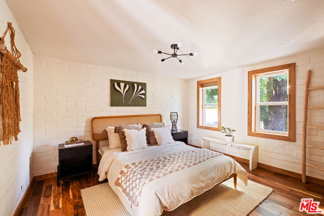 7900 Rim Canyon Road Sunland, CA 91040 - Photo 22 of 46 a bedroom with a bed and wooden floor