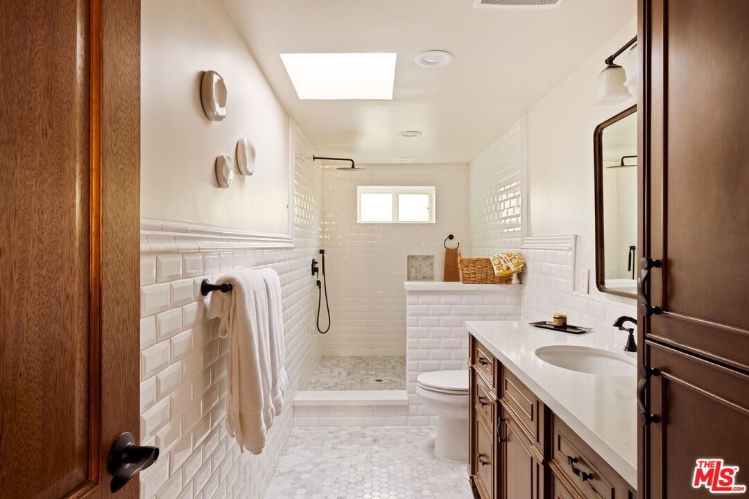 7900 Rim Canyon Road Sunland, CA 91040 - Photo 24 of 46 a bathroom with a sink a mirror and shower