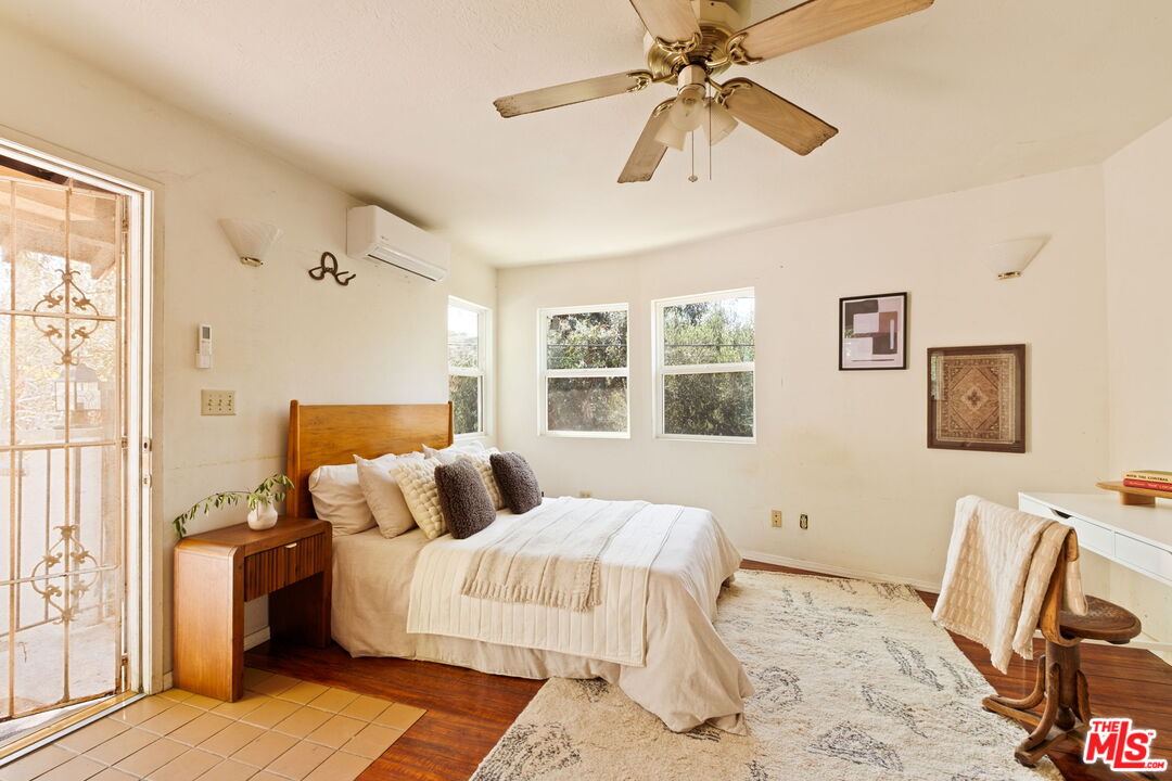7900 Rim Canyon Road Sunland, CA 91040 - Photo 31 of 46 a bedroom with a bed wooden floor and window