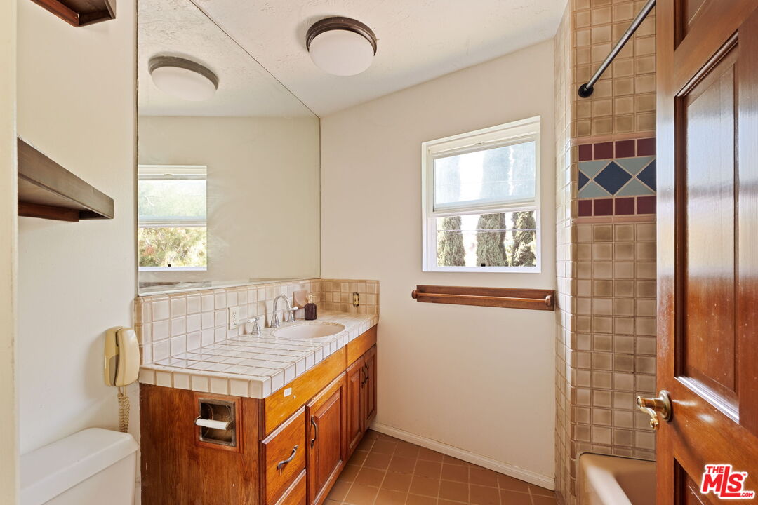 7900 Rim Canyon Road Sunland, CA 91040 - Photo 33 of 46 a bathroom with a granite countertop sink and a mirror