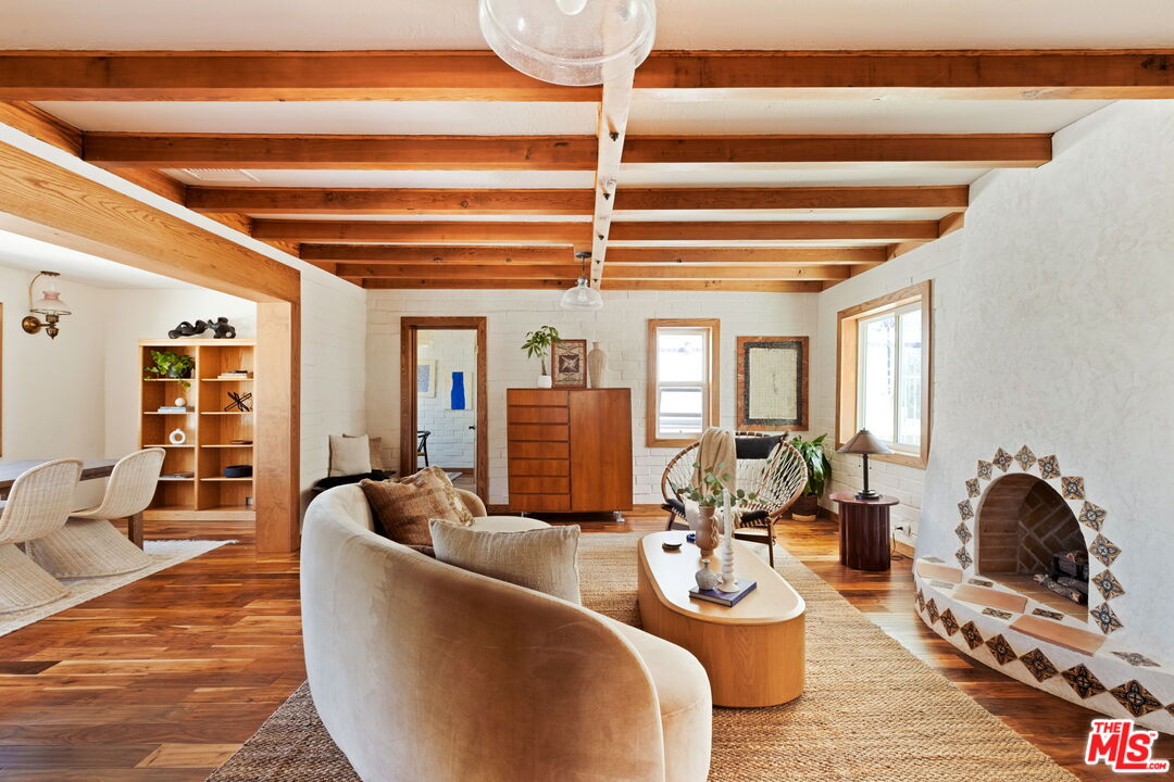7900 Rim Canyon Road Sunland, CA 91040 - Photo 7 of 46 a living room with furniture a fireplace and wooden floor