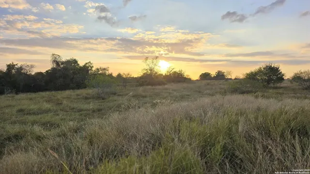 a view of lake with green field