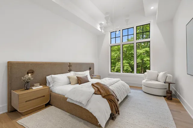 a living room with furniture and large windows