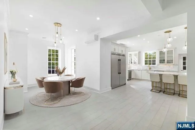 a view of a living room and kitchen with furniture