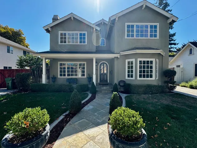 a front view of a house with a garden