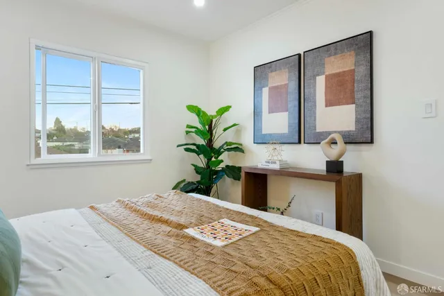 a bedroom with a bed and window