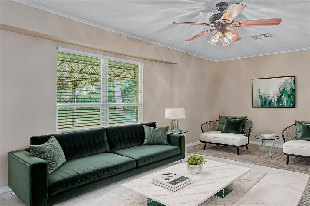 9342 Dean Road Shreveport, LA 71118 - Photo 6 of 18 Spacious room featuring light-toned walls, crown molding, a ceiling fan with integrated lighting, and a large window with horizontal blinds