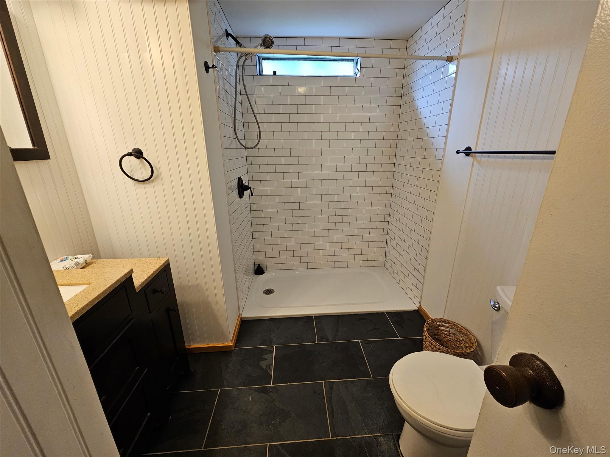 1964-106 River Road, Unit 106 Calverton, NY 11933 - Photo 12 of 26 a bathroom with a sink toilet and shower