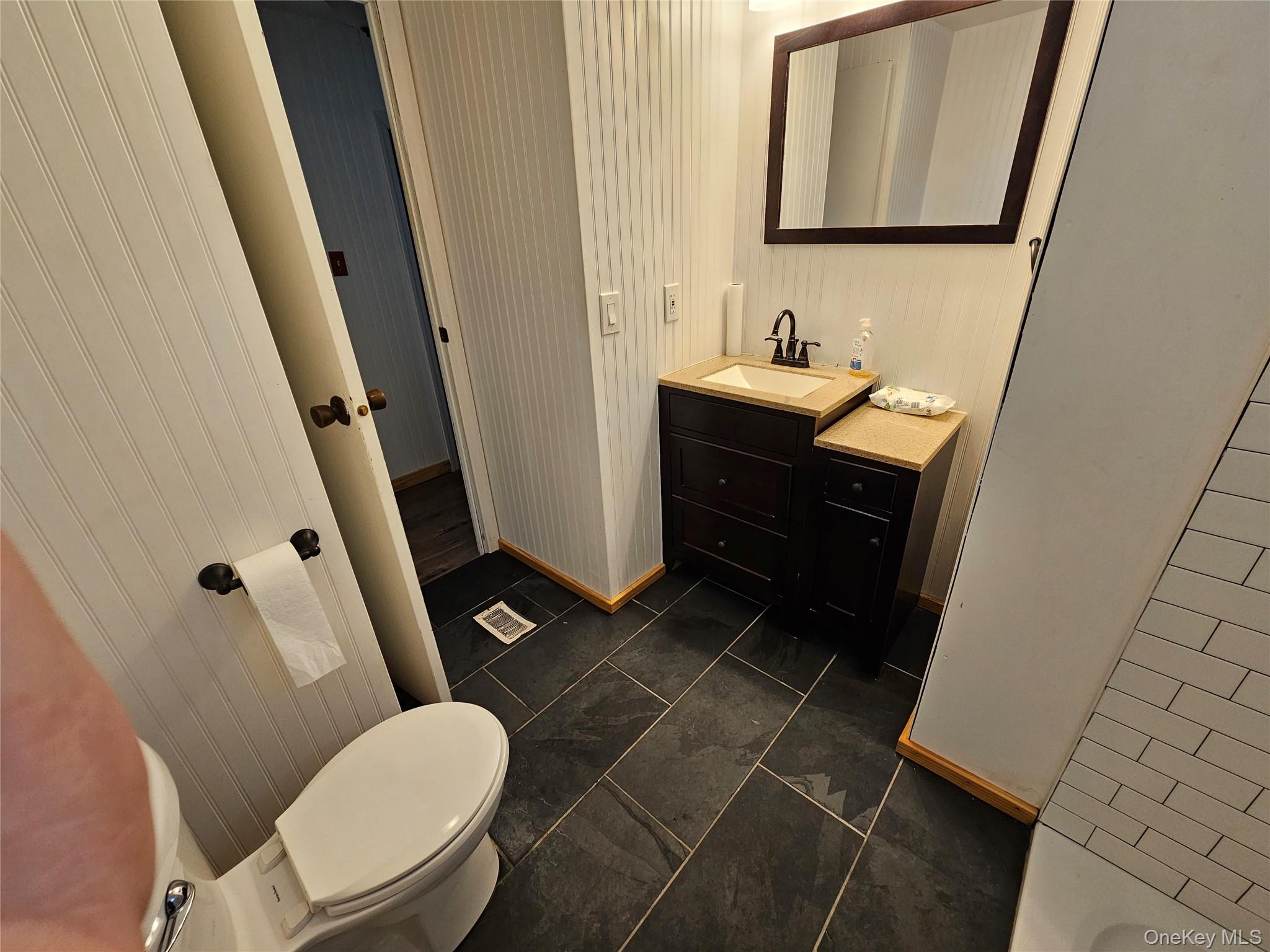 1964-106 River Road, Unit 106 Calverton, NY 11933 - Photo 13 of 26 a bathroom with a sink toilet and mirror