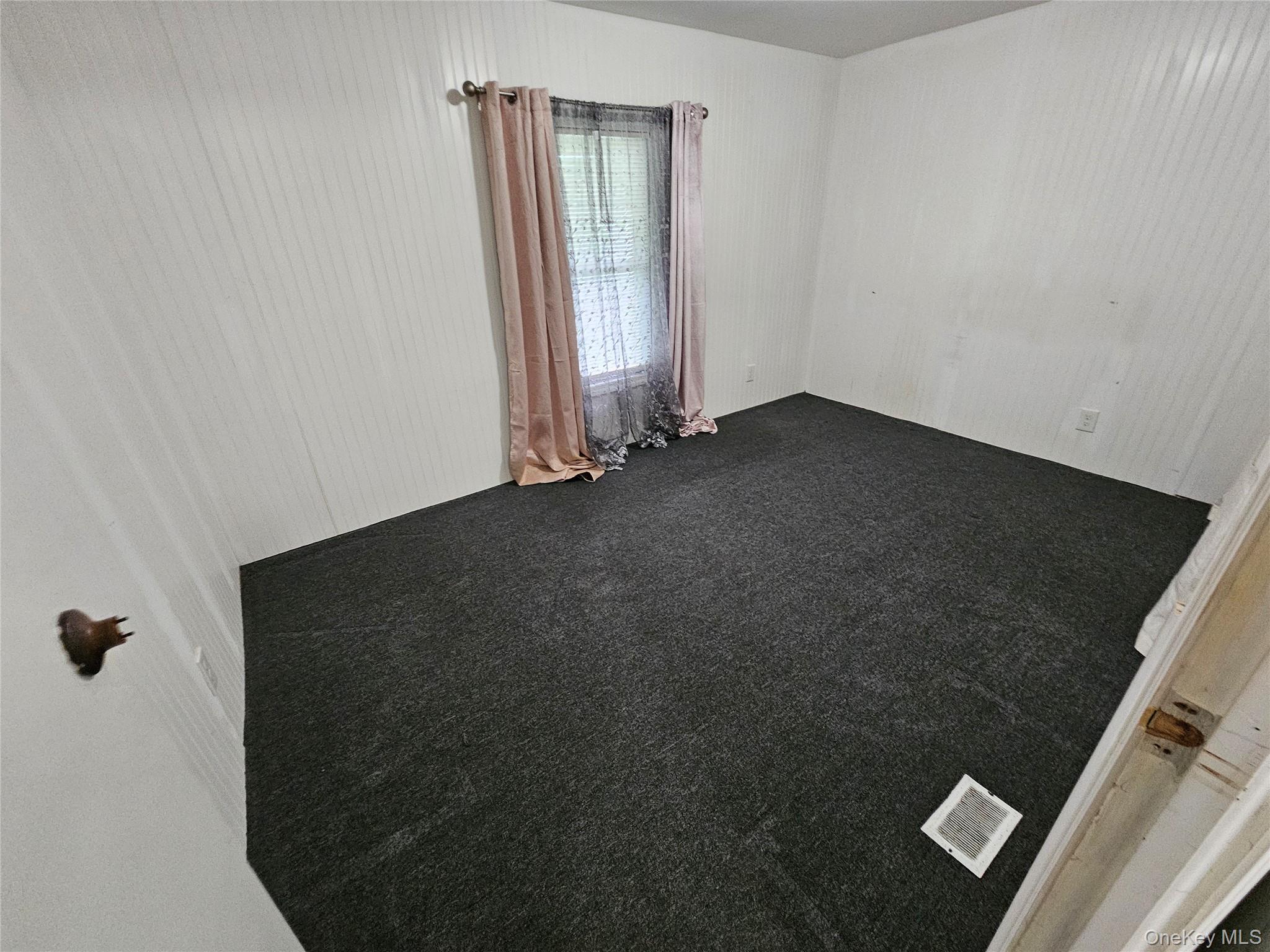 1964-106 River Road, Unit 106 Calverton, NY 11933 - Photo 14 of 26 an empty room with a window