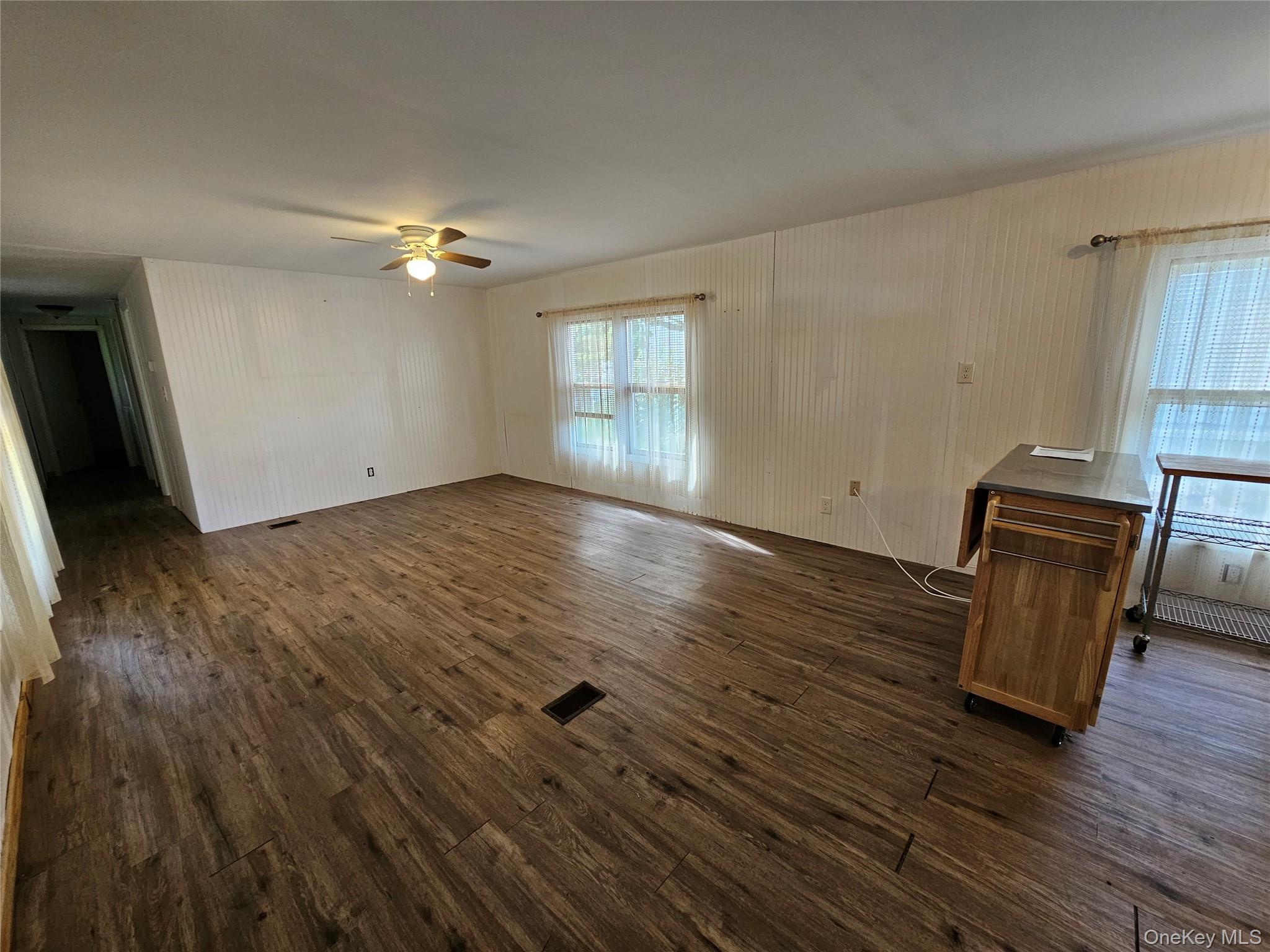 1964-106 River Road, Unit 106 Calverton, NY 11933 - Photo 9 of 26 wooden floor in an empty room with a window