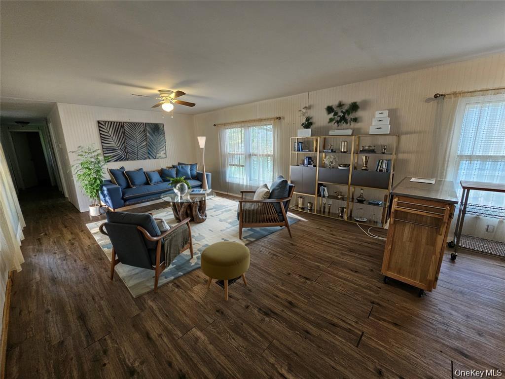 1964-106 River Road, Unit 106 Calverton, NY 11933 - Photo 10 of 26 a living room with furniture and wooden floor