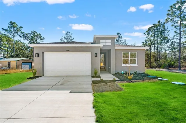 a front view of house with yard and green space