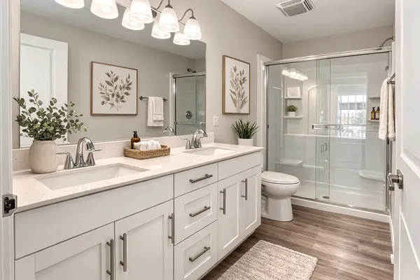 a bathroom with a sink a toilet and shower