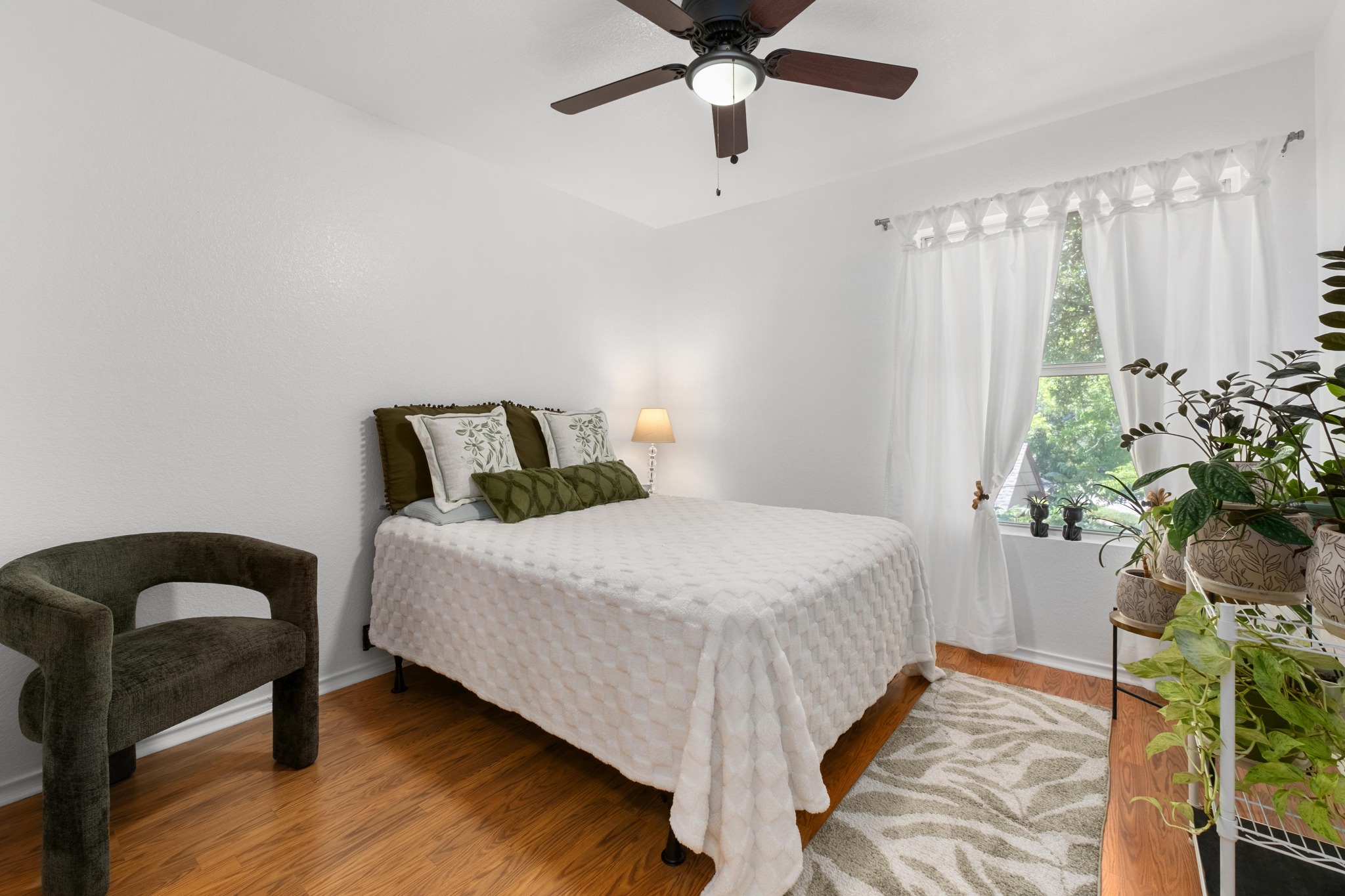 1184 Waller Street Austin, TX 78702 - Photo 10 of 19 a bedroom with bed and a potted plant