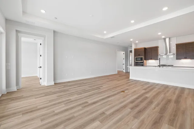 a view of a kitchen with wooden floor and a sink