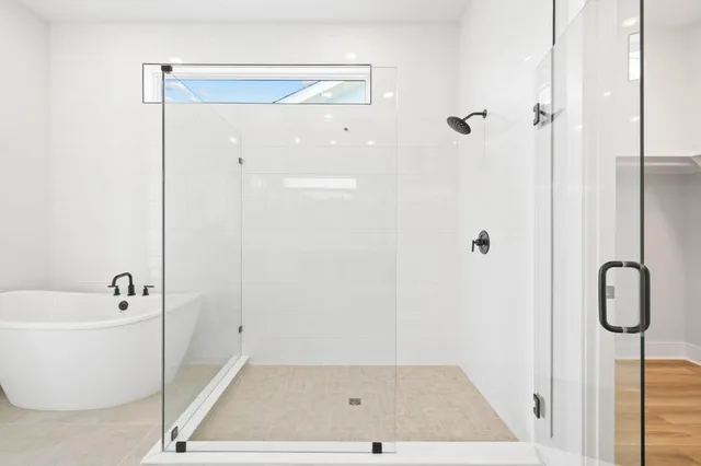 a bathroom with a granite countertop sink mirror and shower