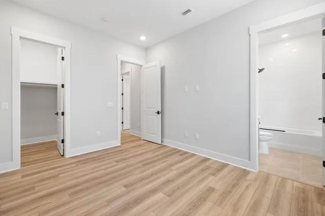 a view of a room with wooden floor and window