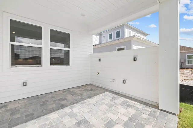 an aerial view of a house with a garden and lake view