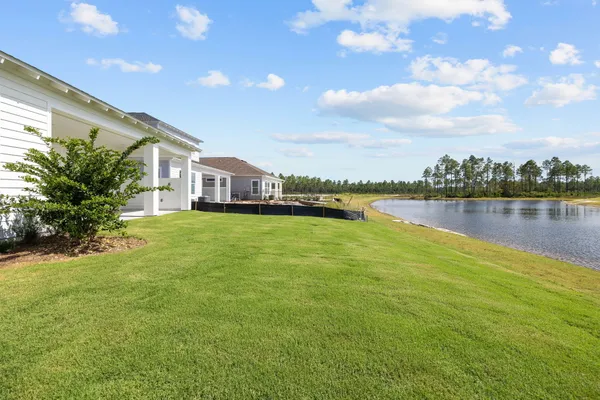 an aerial view of residential house with outdoor space and trees all around