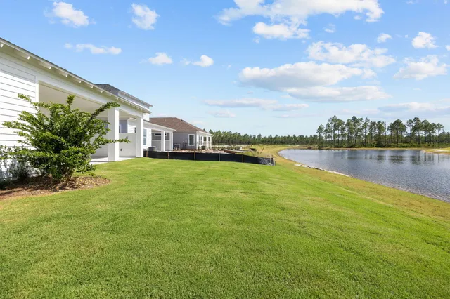an aerial view of residential house with outdoor space and trees all around