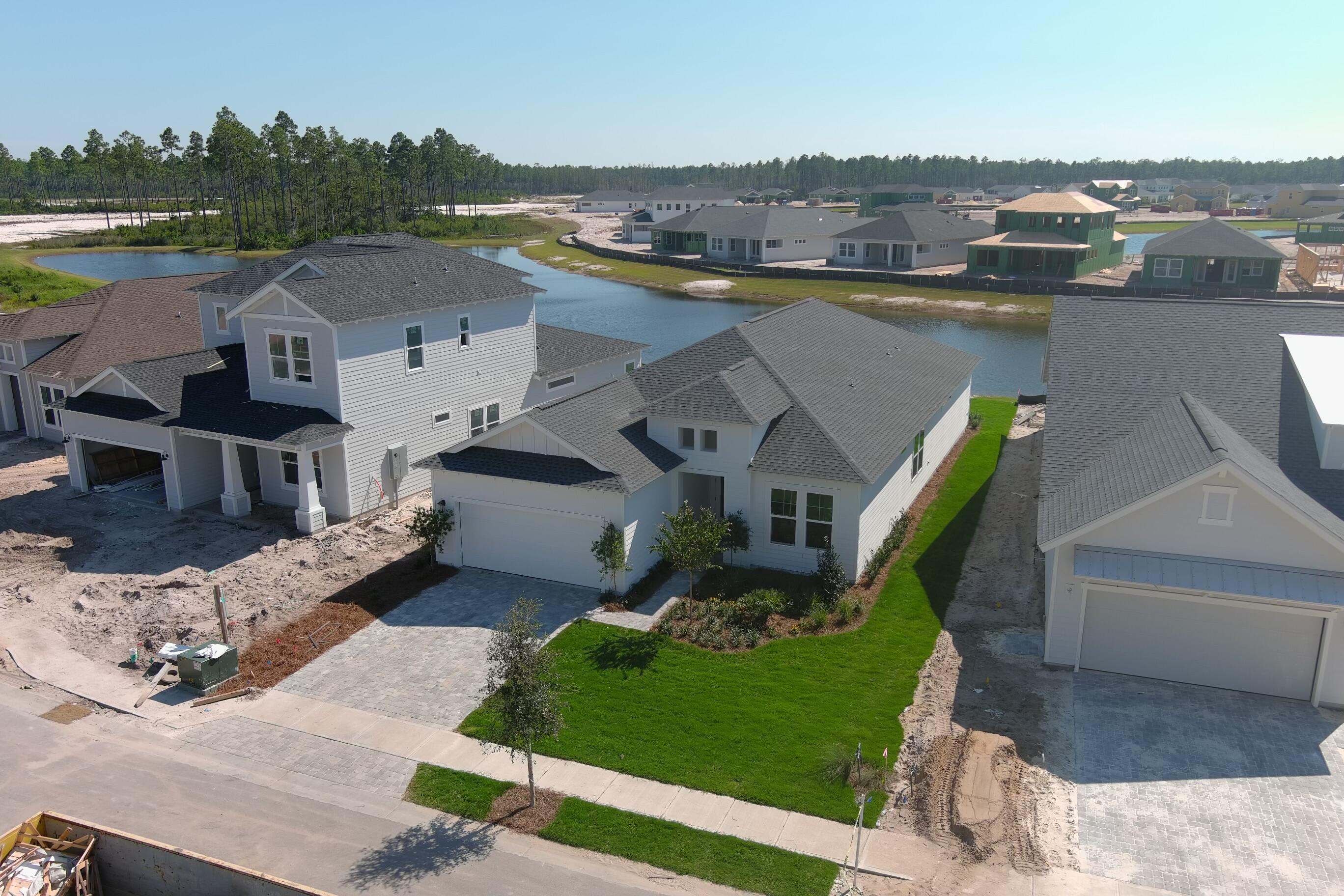 100 Anastasia Cir Inlet Beach Inlet Beach, FL 32461 - Photo 45 of 58 an aerial view of a house with a garden and lake view