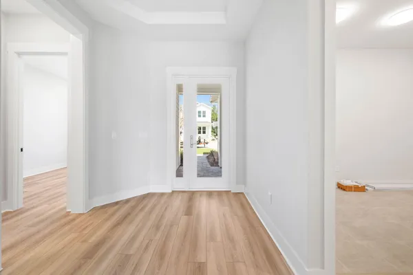 a view of a hallway with wooden floor