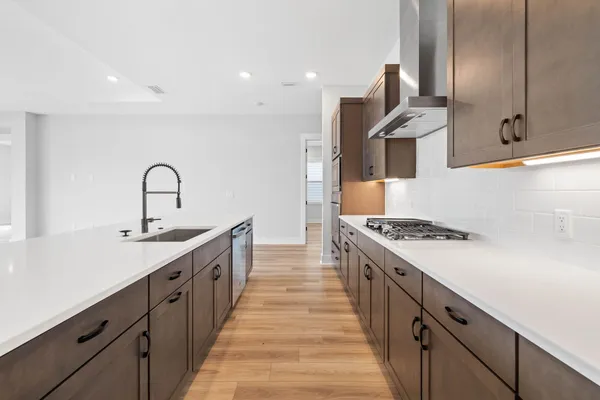 a kitchen with stainless steel appliances granite countertop a sink stove and cabinets