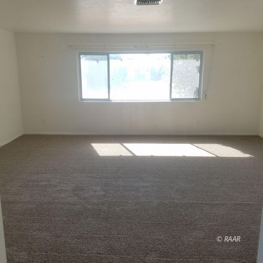 324 West Perdew Avenue Ridgecrest, CA 93555 - Photo 4 of 14 an empty room with a window