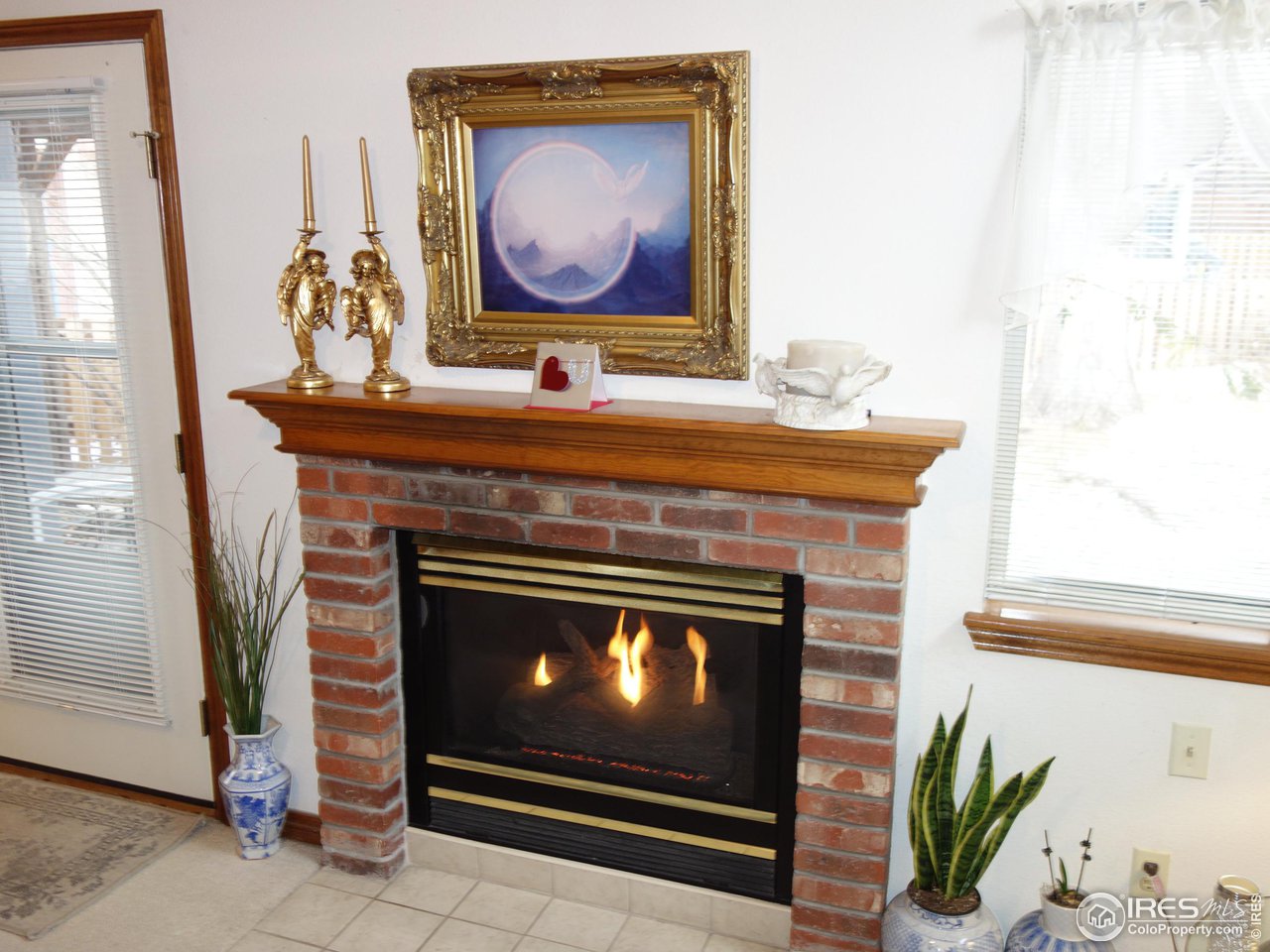 3349 Sentinel Drive Boulder, CO 80301 - Photo 12 of 25 a fireplace with painting on the wall