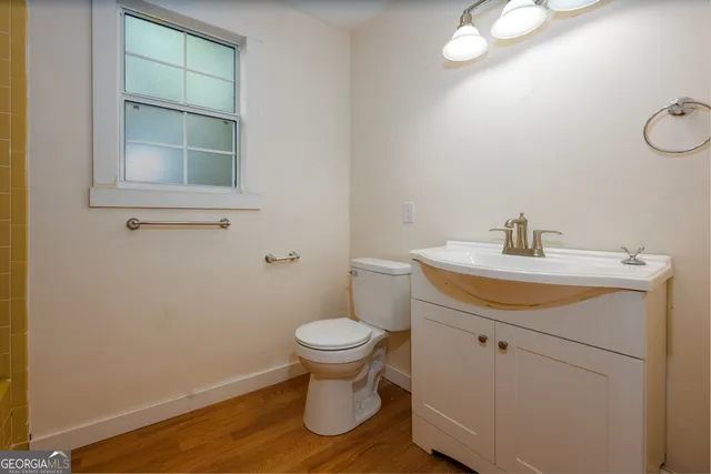 a bathroom with a sink toilet and a mirror