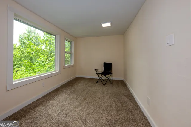 a view of room with a window and a chair