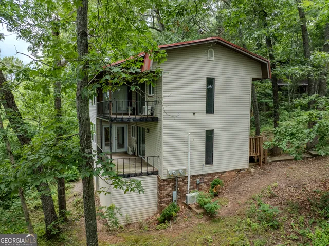a view of a house with a tree and a yard