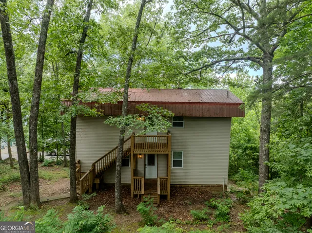 an outdoor space with seating area and trees