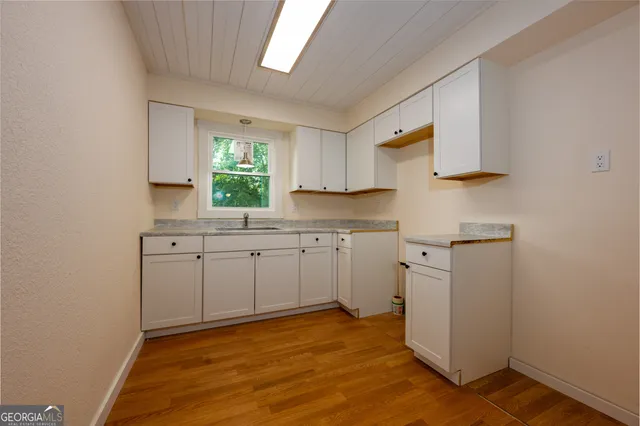 a kitchen with cabinets appliances and a window