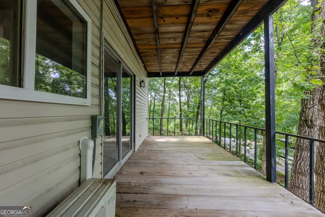 a view of a porch with wooden floor and outdoor space
