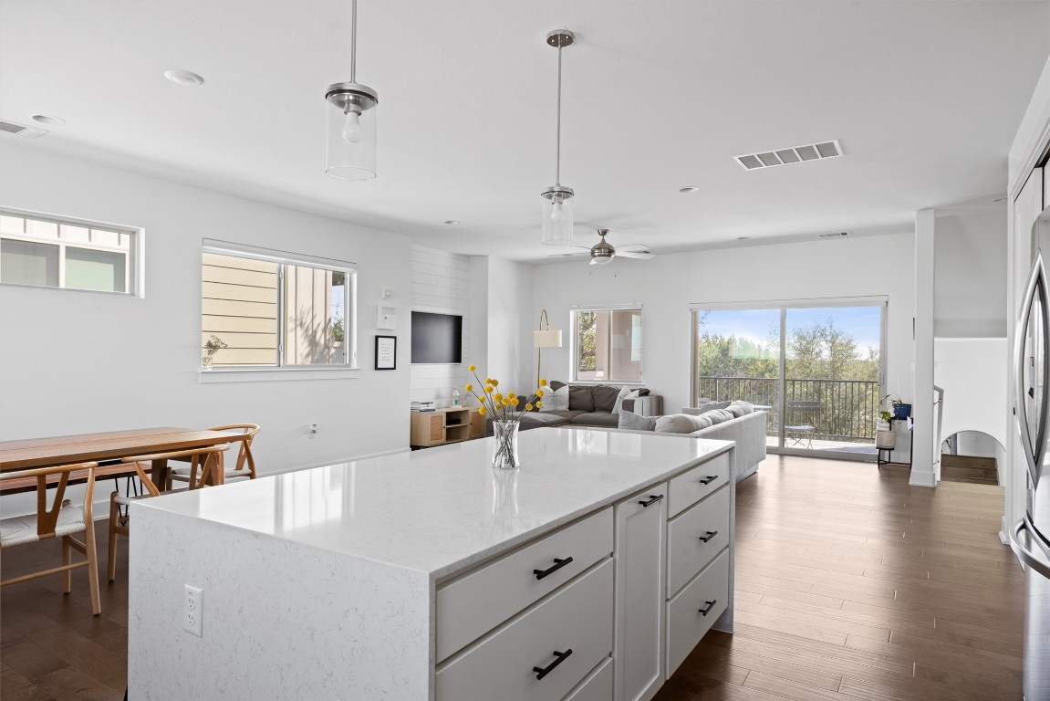 5315 La Crosse Avenue, Unit 18 Austin, TX 78739 - Photo 15 of 40 Kitchen featuring wood-style floors, decorative light fixtures, and white cabinets