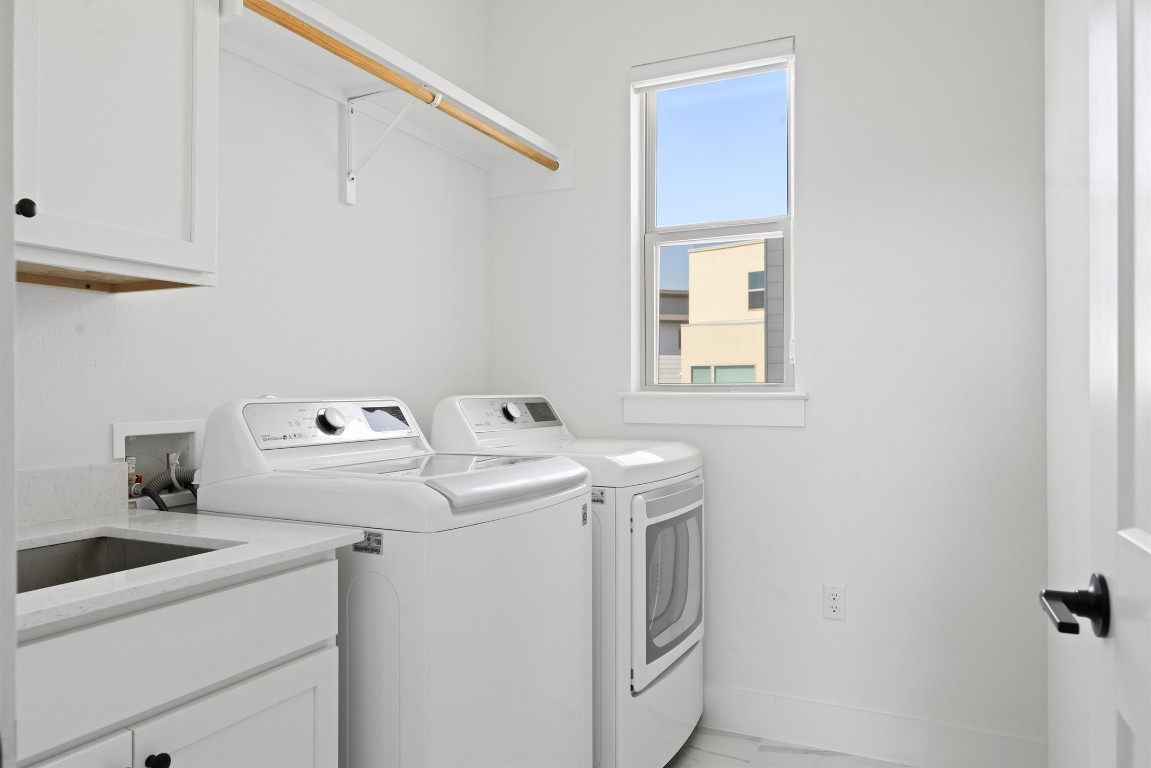 5315 La Crosse Avenue, Unit 18 Austin, TX 78739 - Photo 22 of 40 Laundry room featuring cabinet space and independent washer and dryer