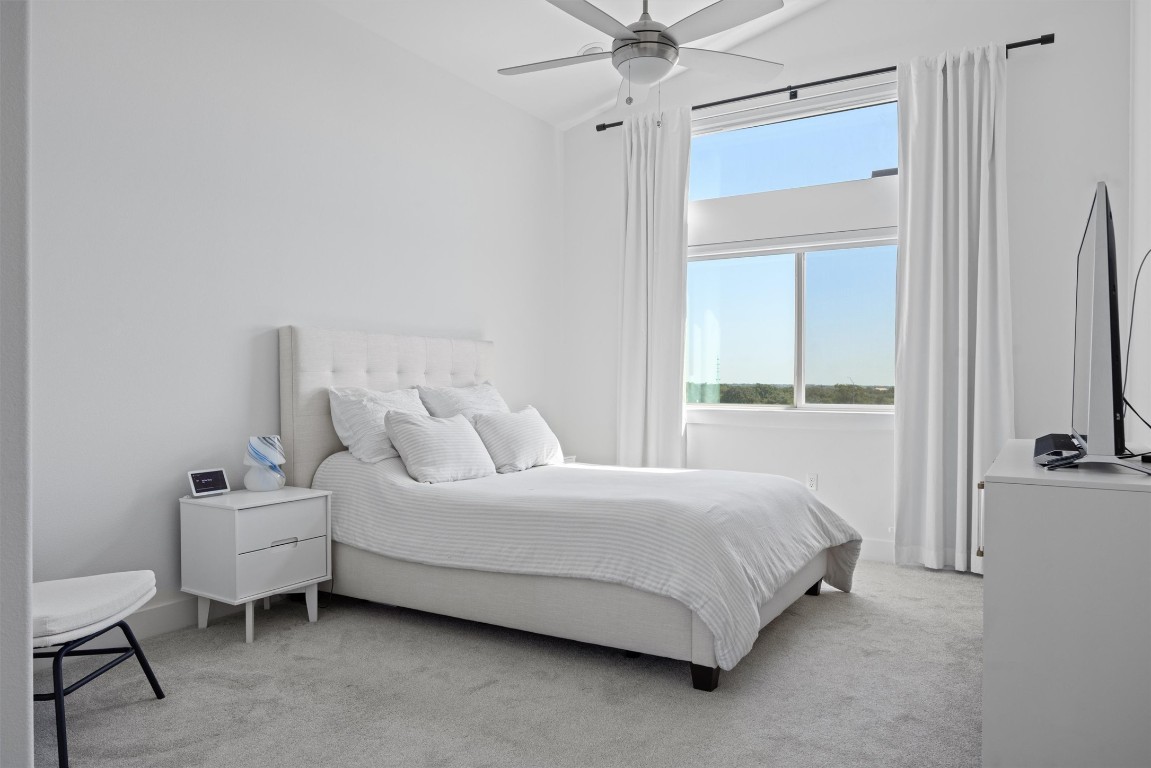 5315 La Crosse Avenue, Unit 18 Austin, TX 78739 - Photo 24 of 40 Bedroom featuring light colored carpet and ceiling fan