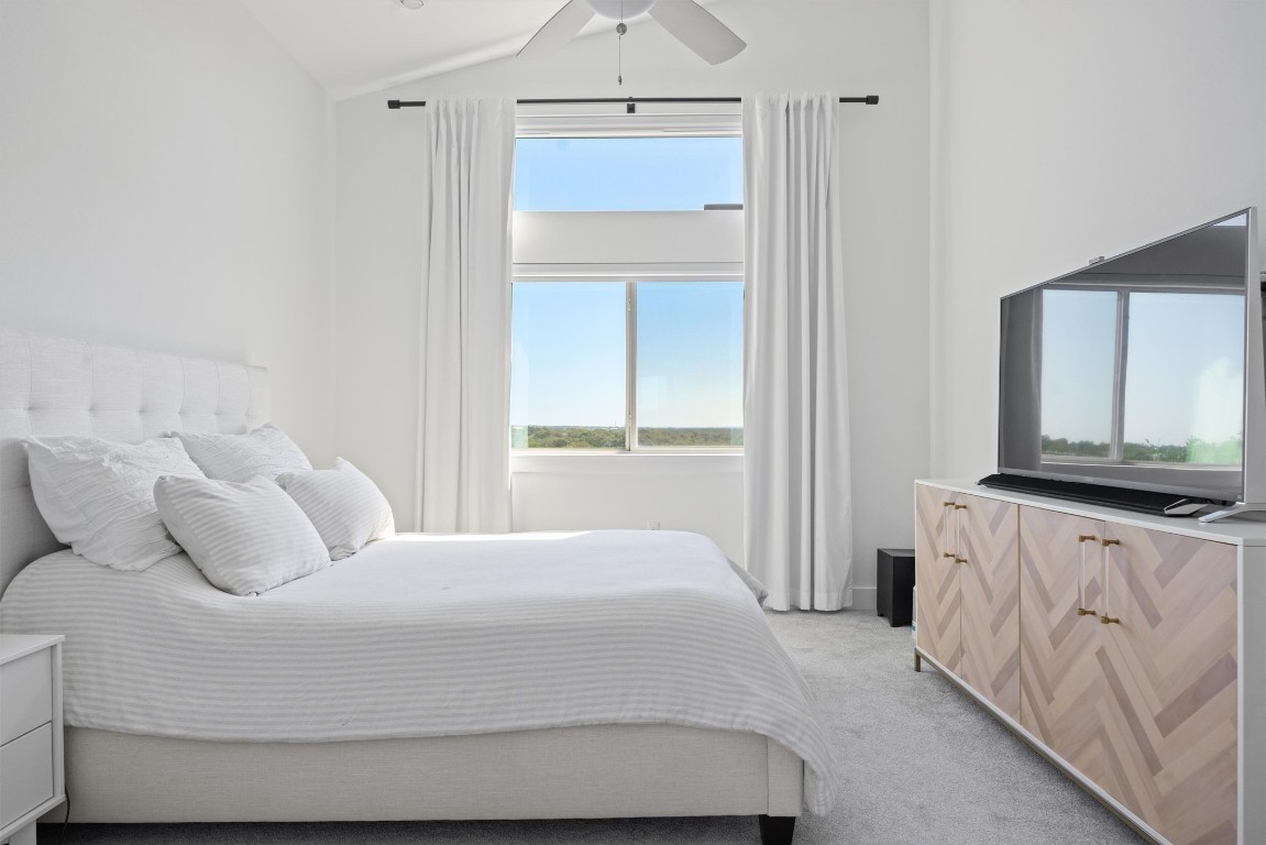 5315 La Crosse Avenue, Unit 18 Austin, TX 78739 - Photo 25 of 40 Bedroom with light carpet, ceiling fan, and lofted ceiling