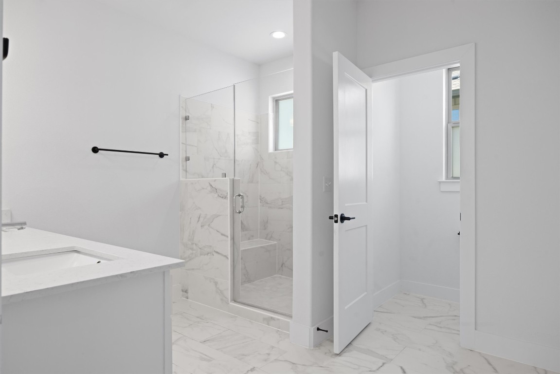 5315 La Crosse Avenue, Unit 18 Austin, TX 78739 - Photo 26 of 40 Full bathroom with a marble finish shower, double vanity, and light marble finish floors