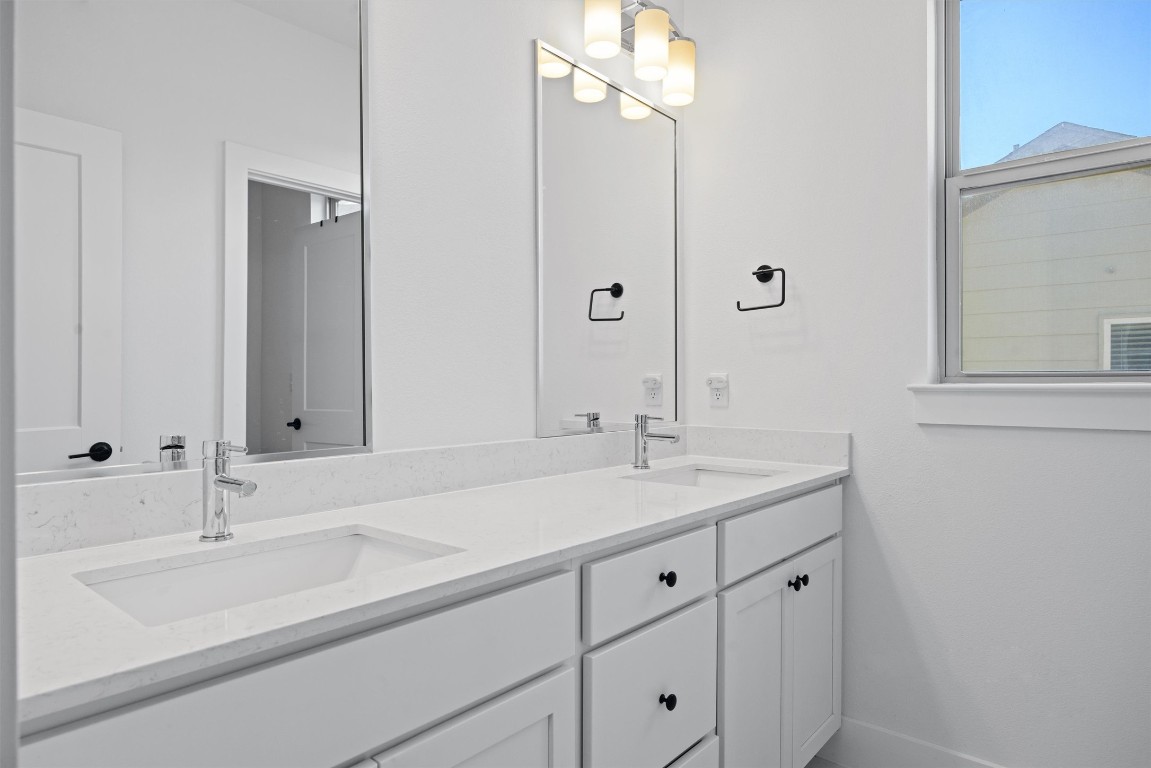 5315 La Crosse Avenue, Unit 18 Austin, TX 78739 - Photo 31 of 40 Bathroom featuring double vanity and baseboards