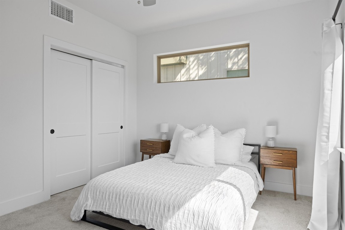 5315 La Crosse Avenue, Unit 18 Austin, TX 78739 - Photo 5 of 40 Bedroom featuring light carpet, a closet, and ceiling fan